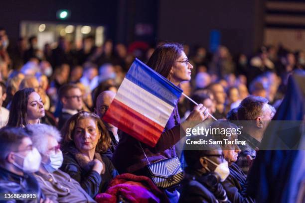 Supporter of Marine Le Pen holds a French flag as the National Rally leader launches her presidential campaign, on February 5, 2022 in Reims, France....