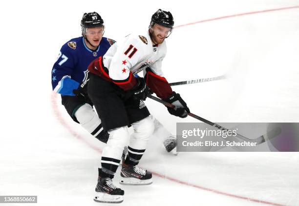 Kirill Kaprizov of the Minnesota Wild of the Central Division and Jonathan Huberdeau of the Florida Panthers of the Atlantic Division skate during...