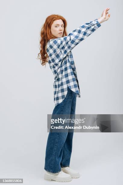 young beautiful woman model posing in new collection of casual clothes in a shirt and jeans in a photo studio on a white background. - hair coloring stock pictures, royalty-free photos & images