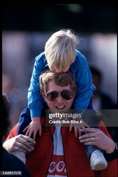 Bill Elliott and his daughter enjoy some time together prior to the Winston Western 500 at California Speedway, November 17, 1985 in Riverside,...