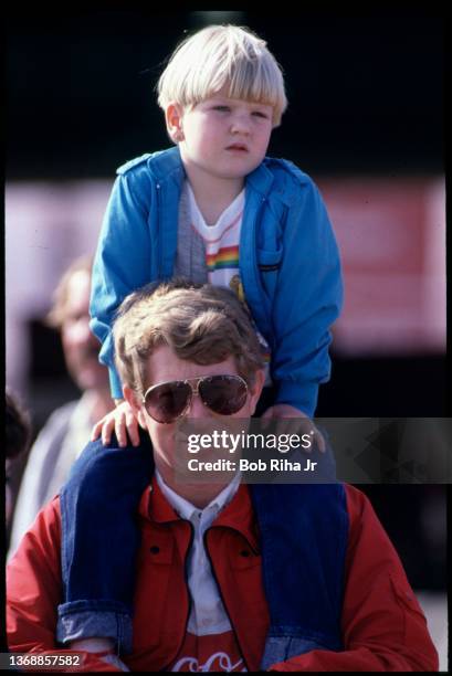 Bill Elliott and his daughter enjoy some time together prior to the Winston Western 500 at California Speedway, November 17, 1985 in Riverside,...