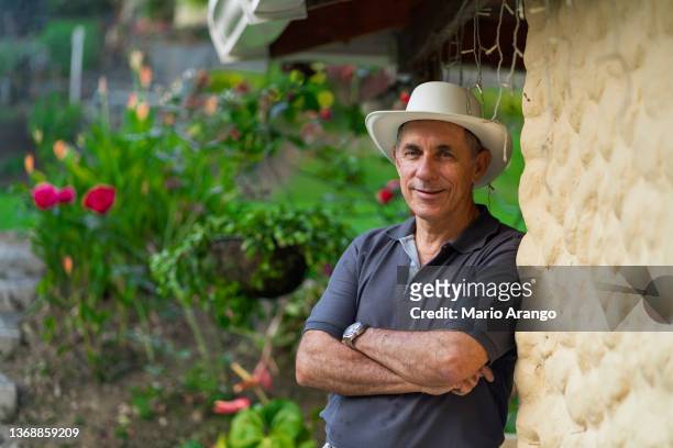 older latino man is on his farm enjoying nature while being photographed - antioquia stock pictures, royalty-free photos & images