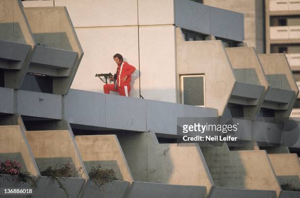 Israeli Hostage Crisis: 1972 Summer Olympics: Police officer with gun, rifle on rooftop during crisis at 31 Connollystrasse in Olympic Village. 11...