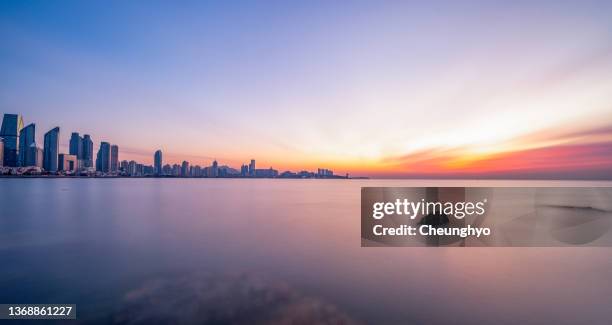 magnificent sunrise glow over qingdao city, shandong province, china, east asia - qingdao beach bildbanksfoton och bilder