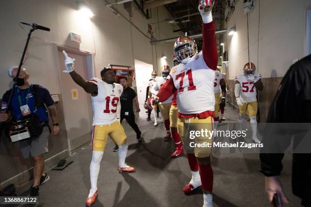 Deebo Samuel and Trent Williams of the San Francisco 49ershead to the field before the game against the Los Angeles Rams at SoFi Stadium on January...