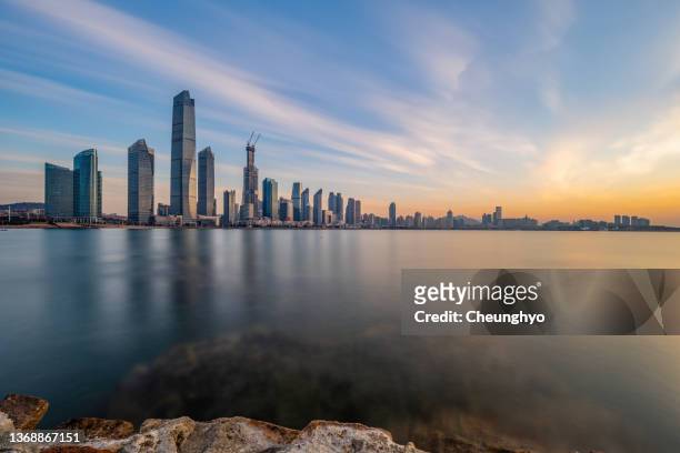 magnificent sunrise glow over qingdao city, shandong province, china, east asia - china east asia stock-fotos und bilder