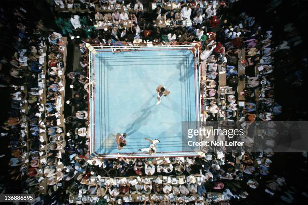 Boxing: WBC/ WBA World Heavyweight Title: Aerial view of Muhammad Ali and George Foreman in ring after bell during round 1 of fight at Stade du 20...