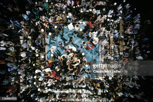 Boxing: WBC/ WBA World Heavyweight Title: Aerial view of Muhammad Ali victorious with cornermen as fans and soldiers rush the ring after round 8...