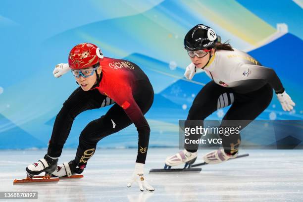 Fan Kexin of Team China and Petra Jaszapati of Team Hungary compete during the Mixed Team Relay Final A on day one of the Beijing 2022 Winter Olympic...