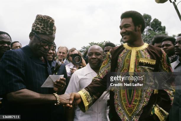 Boxing: WBC/ WBA World Heavyweight Title Preview: George Foreman with Zaire President Mobutu Sese Seku during reception before fight vs Muhammad Ali...