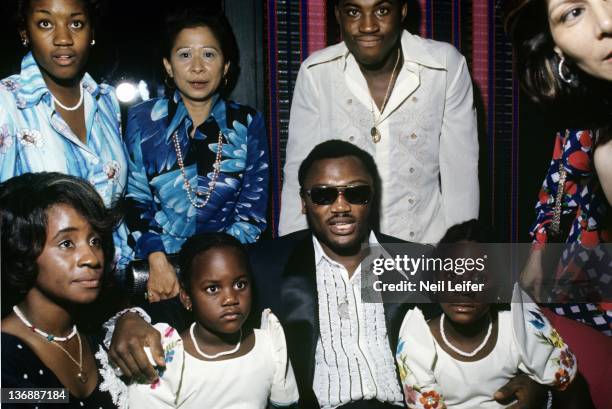 Boxing: WBC/ WBA World Heavyweight Title: Joe Frazier with his family: wife Florence, daughters Natasha and Jo-Netta, and son Marvis during party...