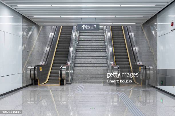 escalator and steps at the exit of the subway station - metro imagens e fotografias de stock