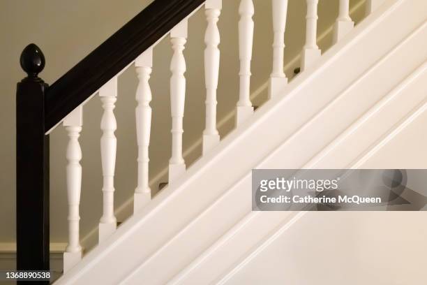 hand carved wooden spindles on old-fashioned bannister of early 20th century tudor home staircase - wooden railing stock pictures, royalty-free photos & images