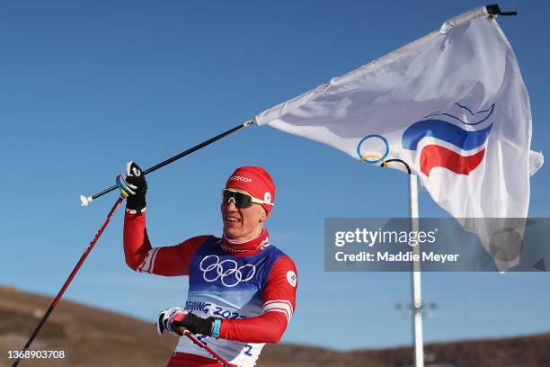 Alexander Bolshunov of Team ROC celebrates after crossing the finish line to win the gold medal during the Men's Cross-Country Skiing 15km + 15km...