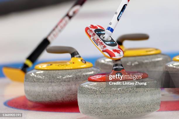 The sweep of Team Canada and Team Czech Republic are seen next to their stones during the Curling Mixed Doubles Round Robin on Day 2 of the Beijing...