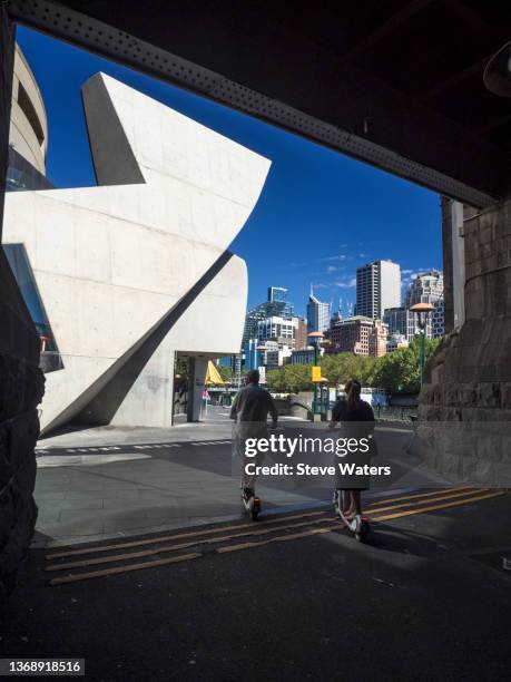 a couple on e-scooters exit the tunnel under princes bridge by the yarra river, southbank - southbank imagens e fotografias de stock