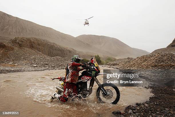 Joan Barreda Bort of Spain and the Husqvarna Rallye team cross a river during stage eleven of the 2012 Dakar Rally from Arica to Arequipa on January...