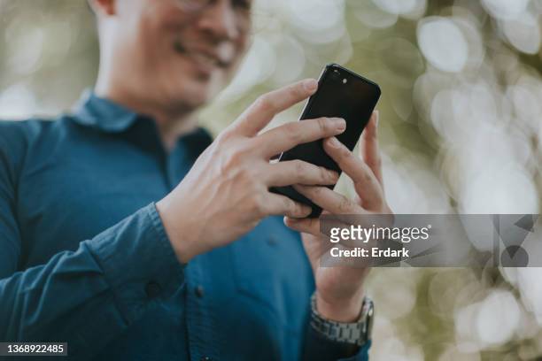 sales manager checking order in his mobile phone. - phone interview event stock pictures, royalty-free photos & images