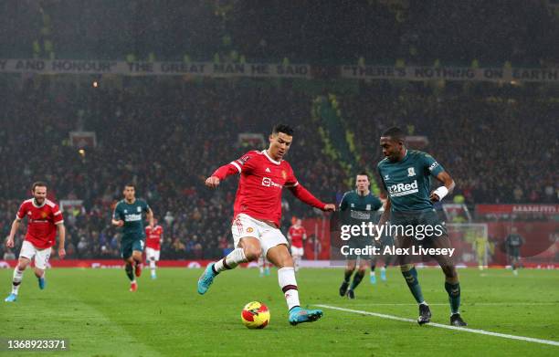 Cristiano Ronaldo of Manchester United is challenged by Anfernee Dijksteel of Middlesbrough during the Emirates FA Cup Fourth Round match between...