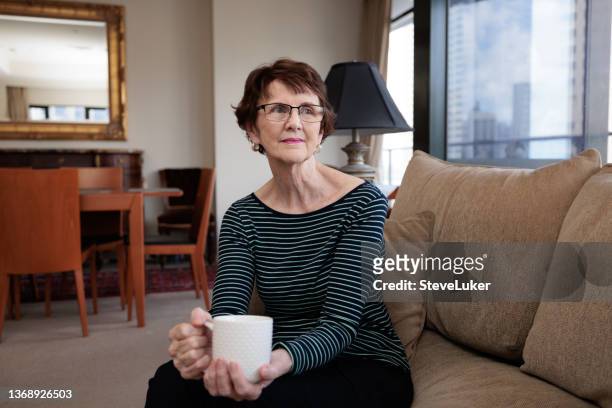 happy senior woman with coffee - brunette woman stock pictures, royalty-free photos & images