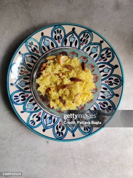 india celebrates the onset or arrival of spring with sweet safron yellow rice - jaggery stock pictures, royalty-free photos & images