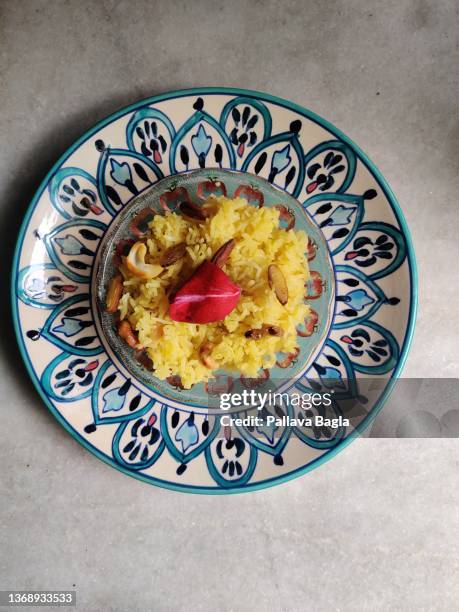 india celebrates the onset or arrival of spring with sweet safron yellow rice - jaggery stock pictures, royalty-free photos & images