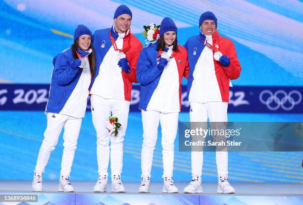 Silver Medalists Anais Chevalier-Bouchet, Emilien Jacquelin, Julia Simon and Quentin Fillon Maillet of Team France celebrate during the Biathlon...