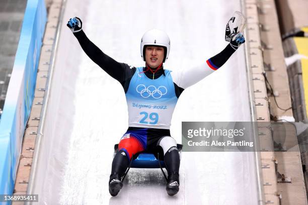 Namkyu Lim of Team South Korea reacts while sliding during the Men's Singles Luge Run 3 on day two of the Beijing 2022 Winter Olympic Games at...