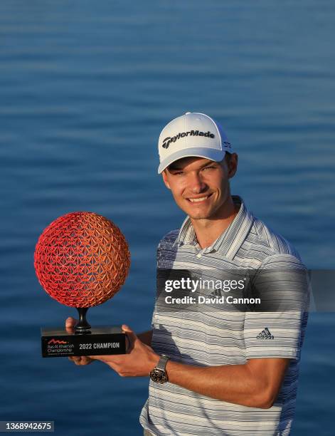 Nicolai Hojgaard of Denmark poses with the trophy after his win on day four of the Ras al Khaimah Championship presented by Phoenix Capital at Al...