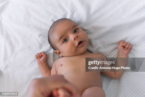 mother changing her baby's diaper. - nappy change imagens e fotografias de stock