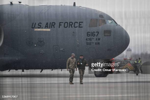 Army General Christopher Donahue and Polish Army General Wojciech Marchwica walk together in front of a U.S. Air Force Boeing C-17A Globemaster III...
