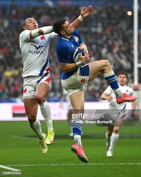 Italy full back Edoardo Padovani takes a high ball under pressure from France centre Gael Fickou during the Guinness Six Nations match between France...