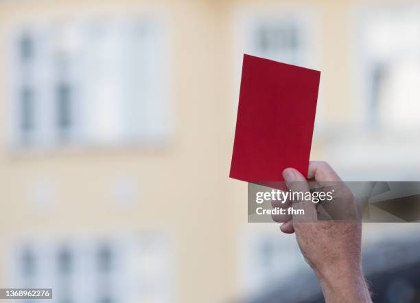 human hand showing a red card - referee stock pictures, royalty-free photos & images