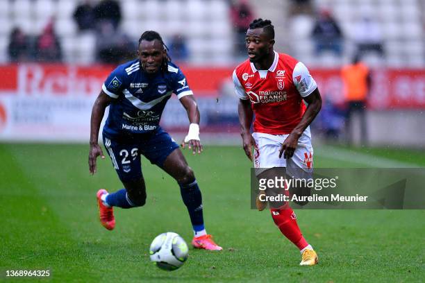 Ghislain Konan of Stade de Reims and Alberth Elis of Girondins de Bordeaux fight for possession during the Ligue 1 Uber Eats match between Reims and...