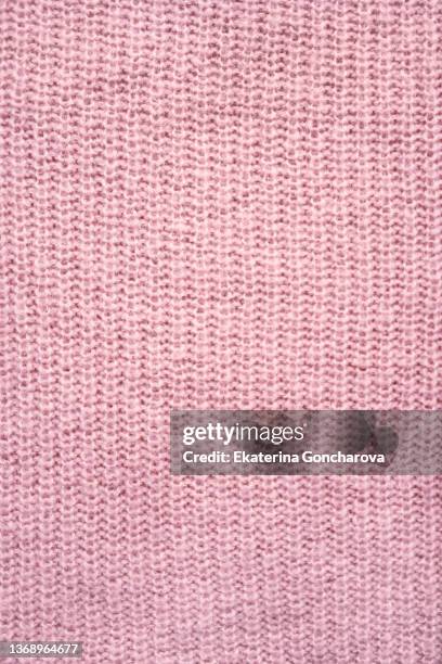 close-up of a knitted fabric, part of a sweater or other hand-knitted clothing. - scarf texture stock pictures, royalty-free photos & images