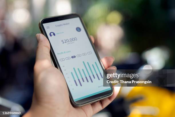 young man checking financial data with mobile banking app on smart phone - アクセス ストックフォトと画像