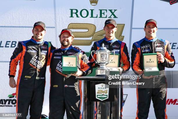 Felipe Fraga, Gar Robinson, Kay van Berlo and Michael Cooper celebrate in victory lane after winning the LMP3 class in the Rolex 24 during the IMSA...