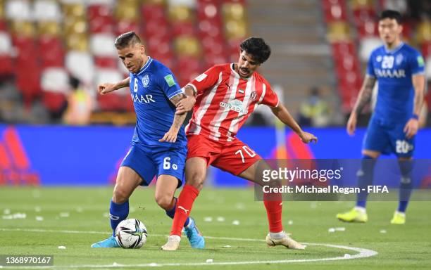 Gustavo Cuellar of Al Hilal battles for possession with Ahmed Al Hashmi of Al Jazira during the FIFA Club World Cup UAE 2021 2nd Round match between...