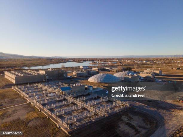 vista aérea de uma estação municipal de tratamento de águas residuais no final da tarde - águas residuais - fotografias e filmes do acervo