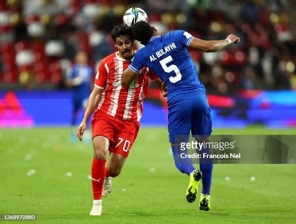 Ahmed Al Hashmi of Al Jazira jumps for the ball with Ali Al Bulayhi of Al Hilal during the FIFA Club World Cup UAE 2021 2nd Round match between Al...