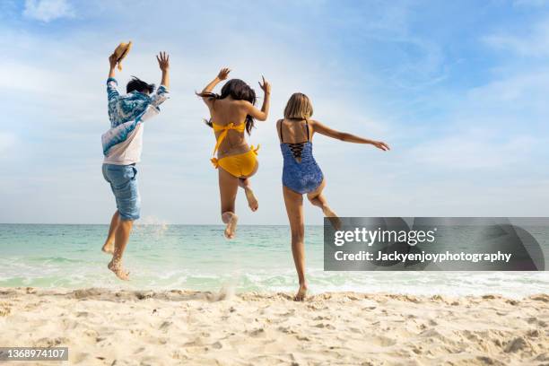 playful friends are running and jumping on the beach - man running food stock pictures, royalty-free photos & images