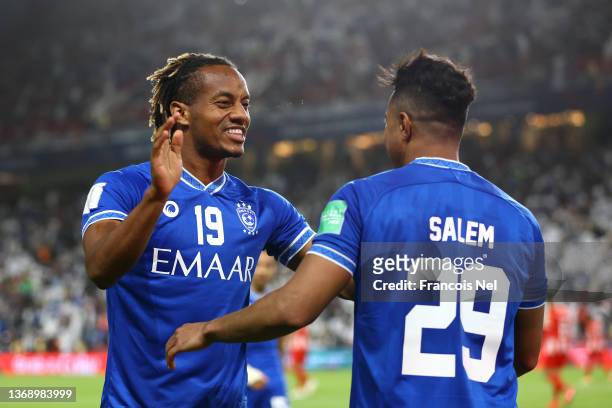 Salem Aldawsari celebrates with teammate Andre Carillo of Al Hilal after scoring their team's fourth goal during the FIFA Club World Cup UAE 2021 2nd...