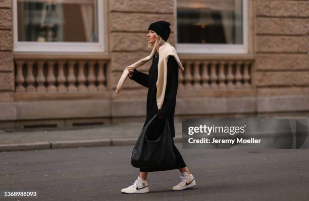 Kathrin Bommann wearing Vival Studios black knit midi dress and black maci dress, Vival Studios black hat, The Row black oversized bag and Uniqlo...