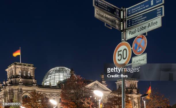 reichstag building with speed limit and other street signs (berlin, germany) - speed limit sign stock pictures, royalty-free photos & images