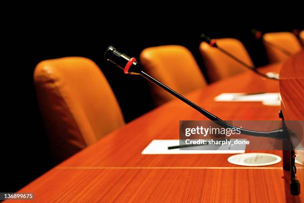 round conference table - press conference microphones stock pictures, royalty-free photos & images