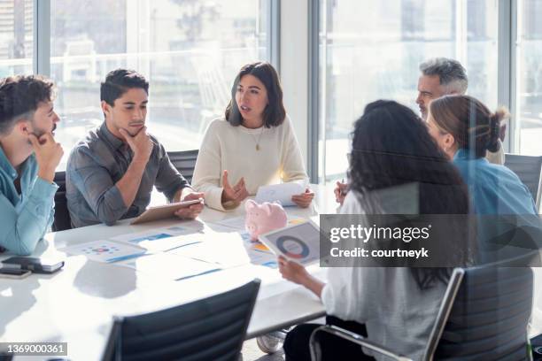 multi racial group of business people with a piggy bank. there are people of different ethnic groups. - market research stock pictures, royalty-free photos & images