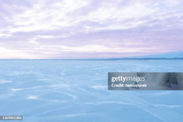 frozen lake - frozen lake sunset stock pictures, royalty-free photos & images