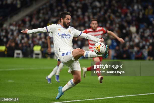Isco Alarcon of Real Madrid controls the ball while Quini of Granada CF looks on during the LaLiga Santander match between Real Madrid CF and Granada...