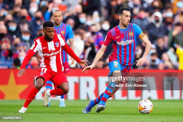 Sergio Busquets of FC Barcelona dribbles Thomas Lemar of Atletico de Madrid during the LaLiga Santander match between FC Barcelona and Club Atletico...