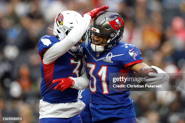 Antoine Winfield Jr. #31 of the Tampa Bay Buccaneers and NFC and Budda Baker of the Arizona Cardinals and NFC react in the first half of the 2022 NFL...